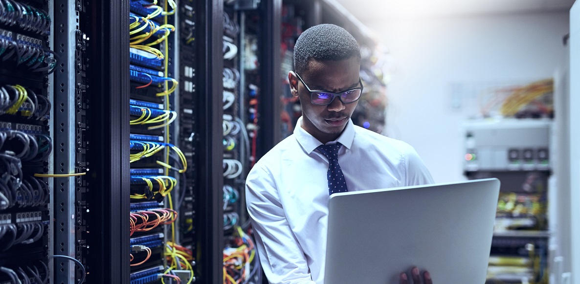 Man in a data center with lead battery energy storage.